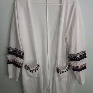 white cardigan sweater, two pockets, braided trim, tee shirt fabric, size small